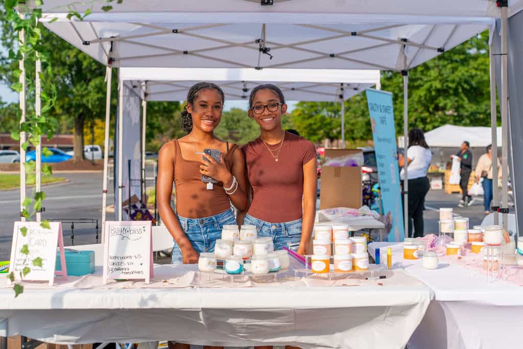 commercial retail property managed by Avison Young, site of ICSC award winning event Kidpreneurs, young contestants stand behind a table of merchandise